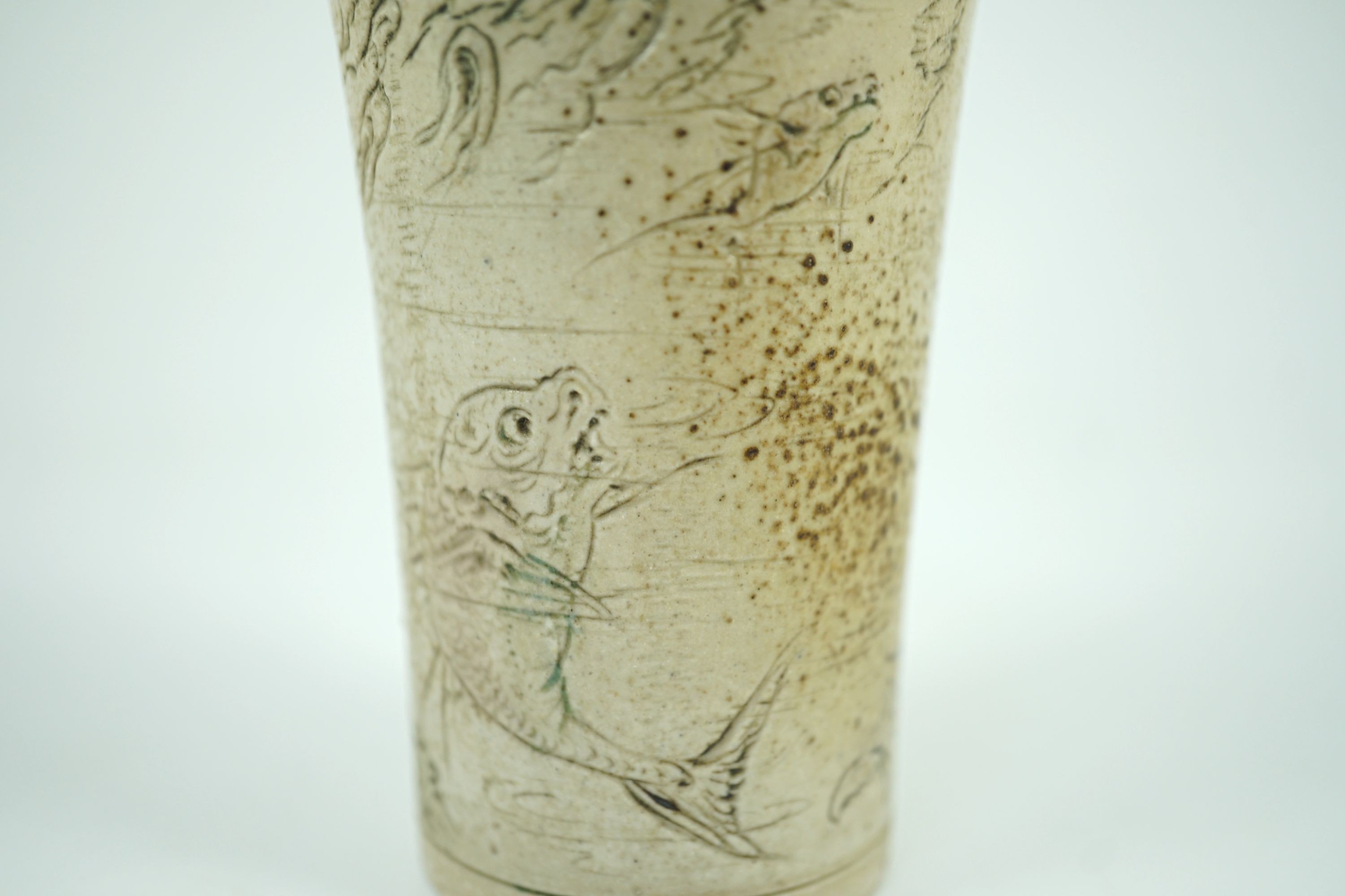 A Martin Brothers ‘grotesque fish’ beaker, dated 1914, 8.7cm high, hairline crack